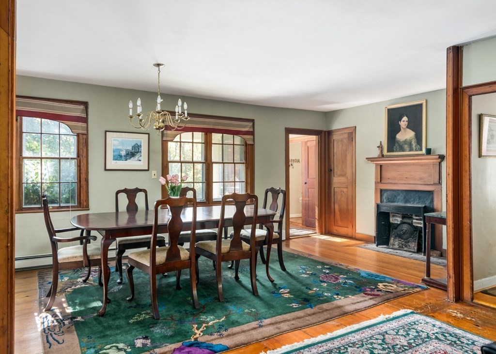 887 Broadway Hanover, MA 02339 - Photo 7 of 27 a dining room with furniture a rug and a floor to ceiling window