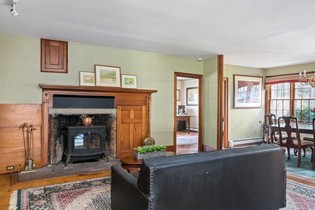 887 Broadway Hanover, MA 02339 - Photo 8 of 27 a living room with furniture and a fireplace
