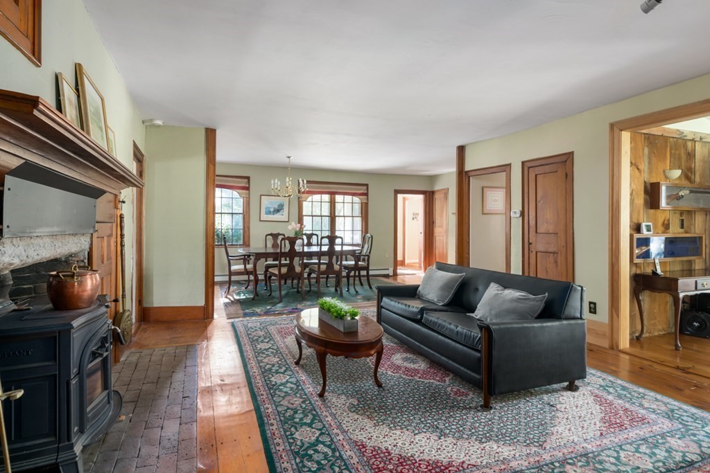 887 Broadway Hanover, MA 02339 - Photo 9 of 27 a living room with furniture and a flat screen tv
