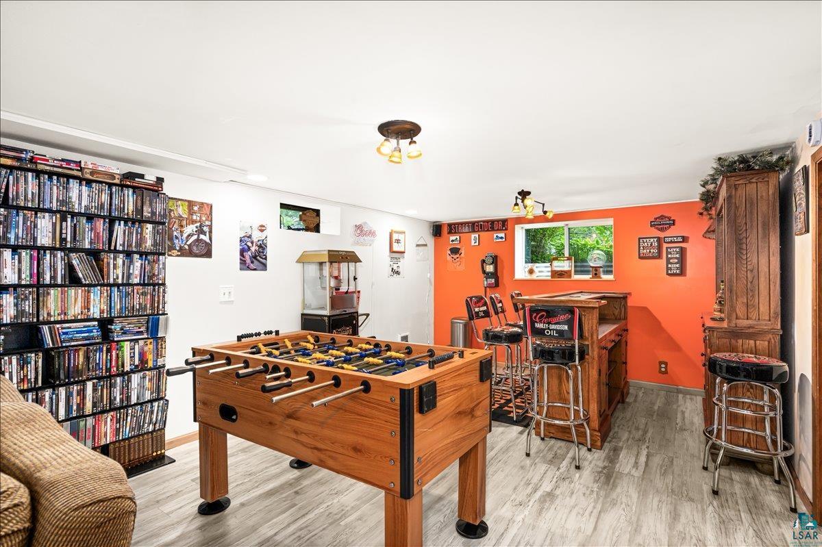 130 West Austin Street Duluth, MN 55803 - Photo 18 of 35 Recreational space featuring wood-finish flooring and a built-in bar with seating