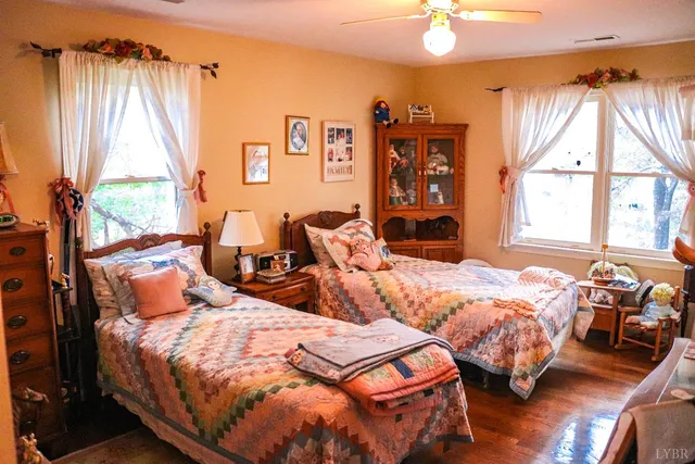a bedroom with two beds and a large window