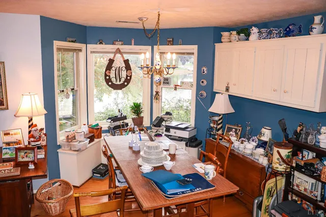 a living room with furniture a large window and a dining table