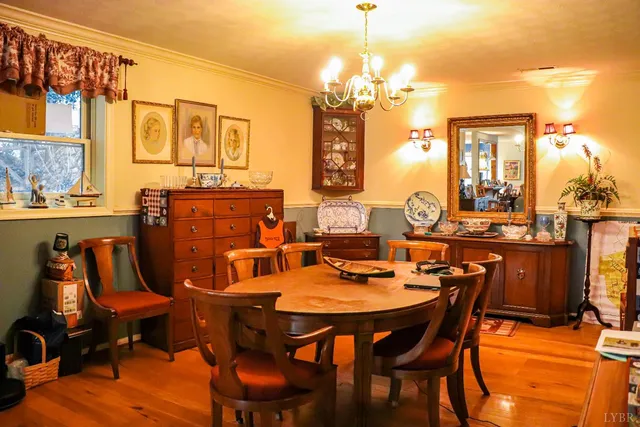 a view of a dining room with furniture and chandelier