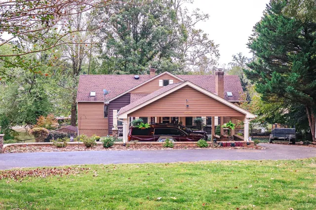 a front view of multiple houses with yard and outdoor seating