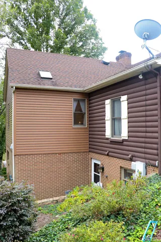 a view of a chairs and table in backyard of the house