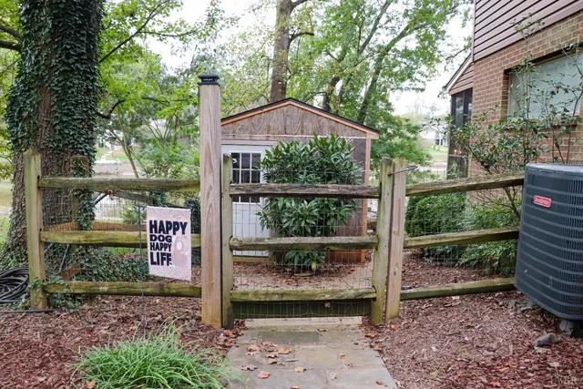 a wooden fence with some trees in the background