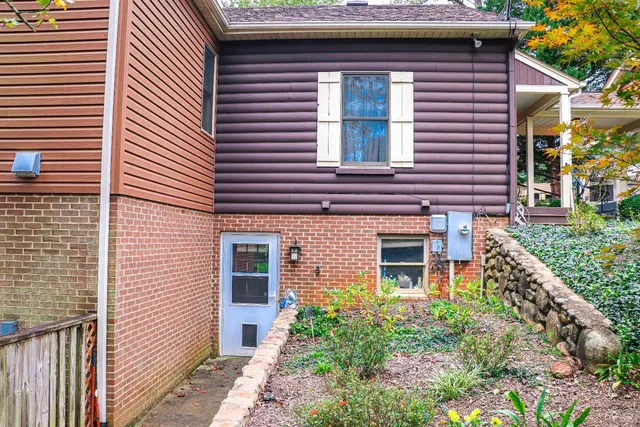 a view of a house with a small yard and potted plants