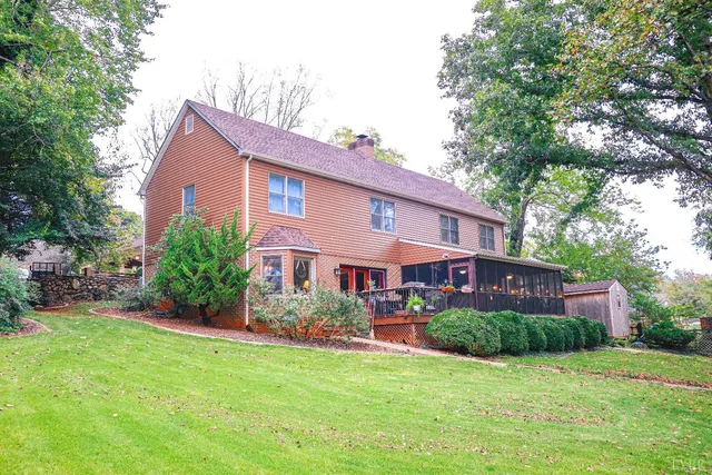a view of a house with a yard and sitting area