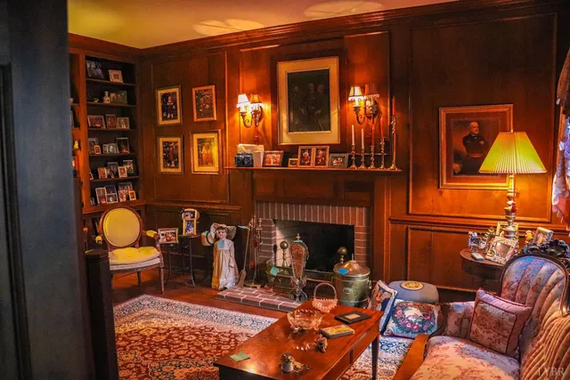 a living room with furniture a rug and a fireplace