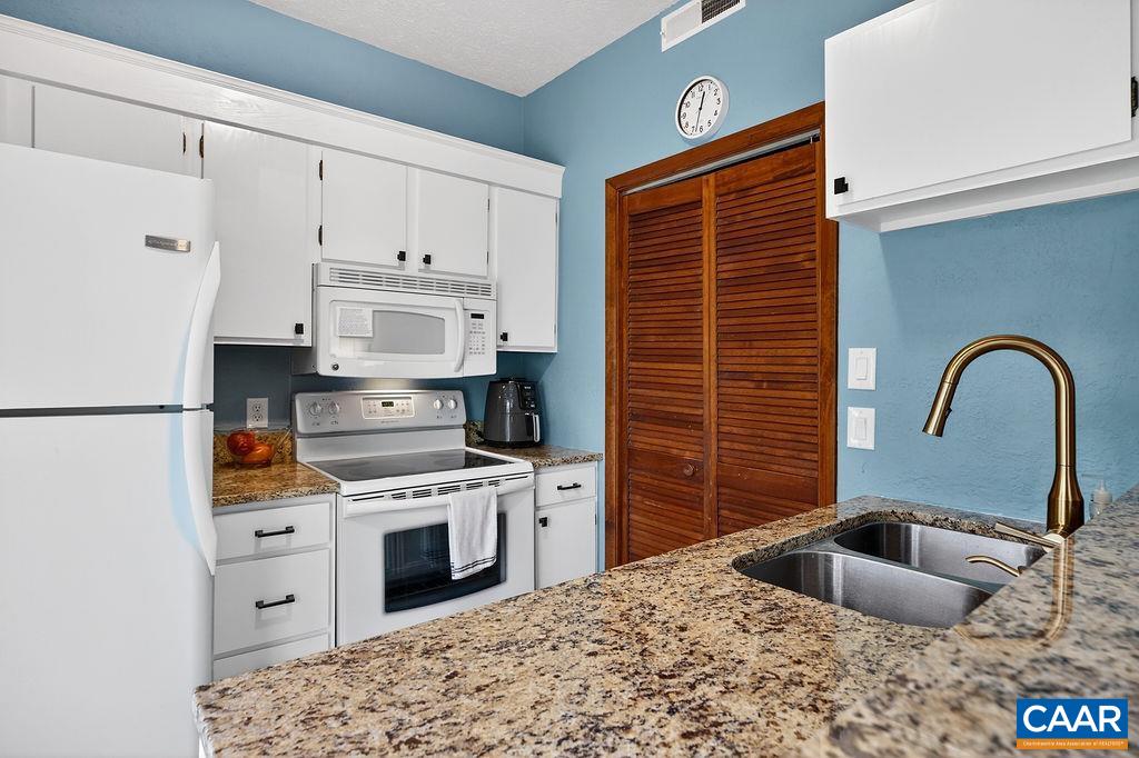 472 Three Ridges Wintergreen, VA 22967 - Photo 9 of 16 a kitchen with stainless steel appliances granite countertop a sink stove and refrigerator