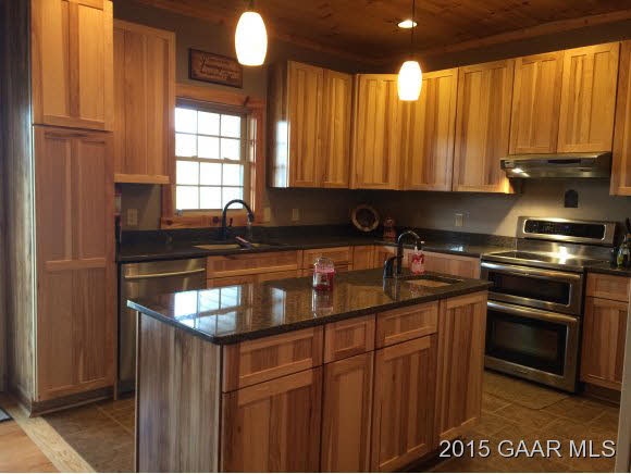 239 Howardsville Road Staunton, VA 24401 - Photo 11 of 20 a kitchen with granite countertop a sink stove and cabinets
