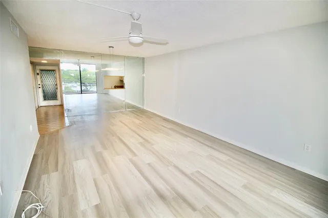 a view of a hallway with wooden floor and a fireplace