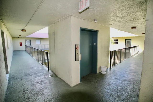 a view of a hallway with dining area and chandelier