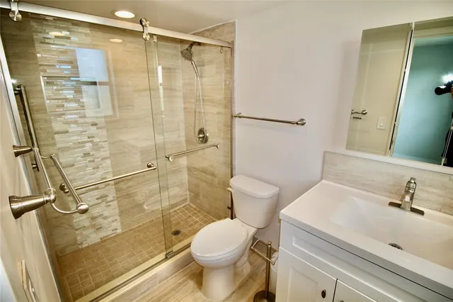 a bathroom with a sink toilet and shower