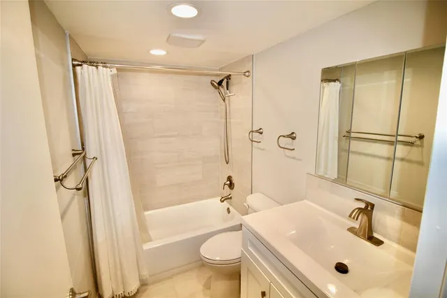 a bathroom with a sink mirror toilet and shower