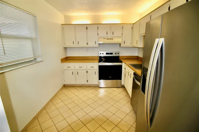 a kitchen with stainless steel appliances a refrigerator and a stove