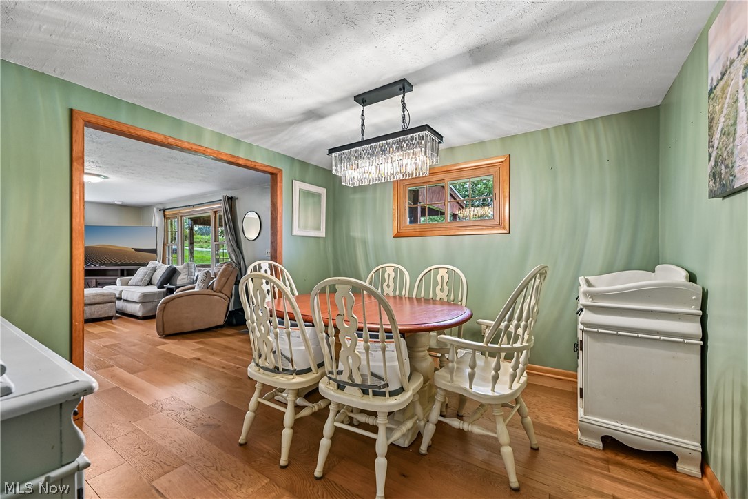 15111 Mt Eaton Road North Rittman, OH 44270 - Photo 10 of 50 Dining room with chandelier and wood flooring