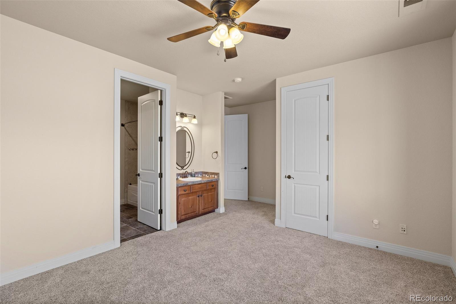 41865 East Muirfield Loop Elizabeth, CO 80107 - Photo 25 of 50 a view of a livingroom with a chandelier fan and windows