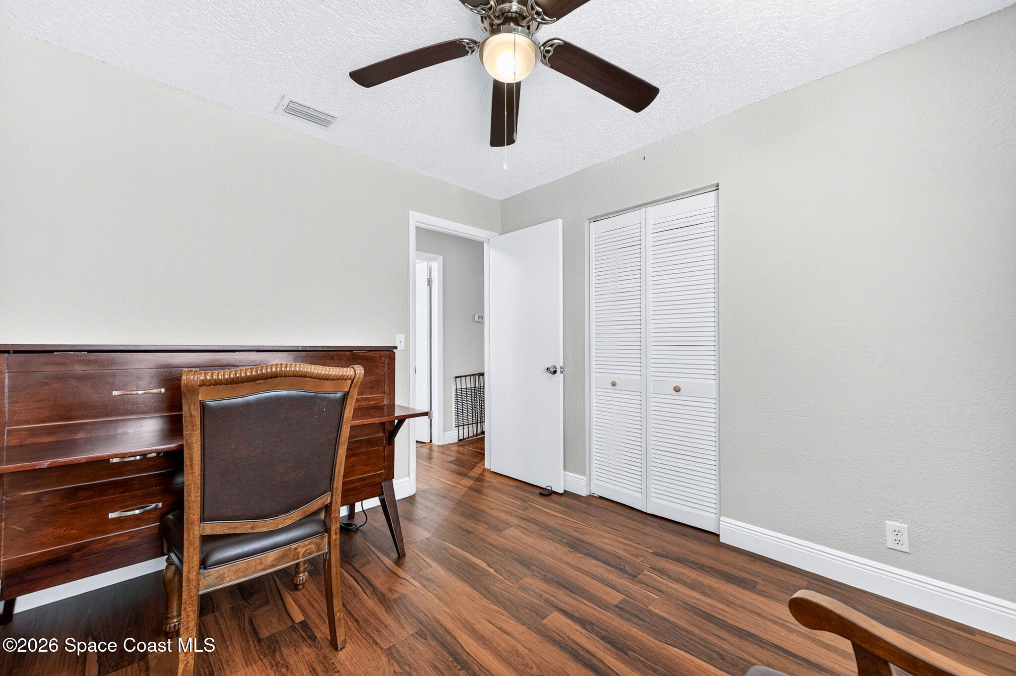 996 Botany Lane Rockledge, FL 32955 - Photo 26 of 35 a room with wooden floor workspace and window