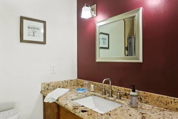 a bathroom with a sink vanity and mirror
