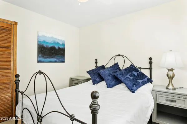 a bathroom with a granite countertop sink toilet and a mirror