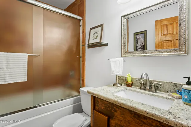 a view of an outdoor dining space with a table and chairs