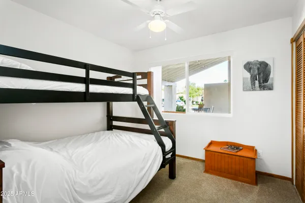 a view of a patio with table and chairs under an umbrella
