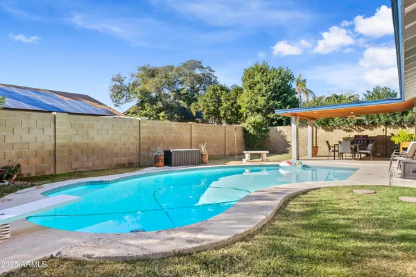 a living room with furniture a rug and a floor to ceiling window