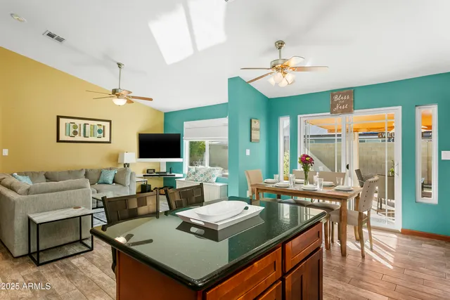 a living room with furniture a flat screen tv and a table