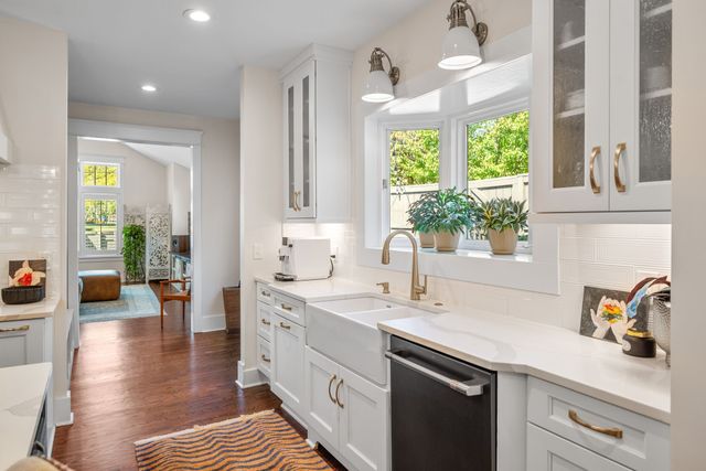 a view of living room with furniture and wooden floor