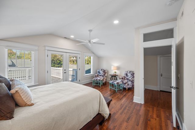 a view of a hallway with wooden floor and entryway