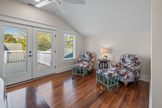 a large living room with stainless steel appliances granite countertop a couch and a view of kitchen