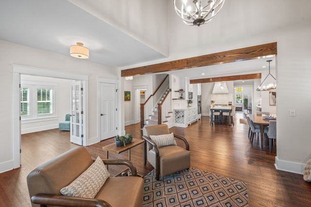 a view of a a dining room with furniture window and wooden floor
