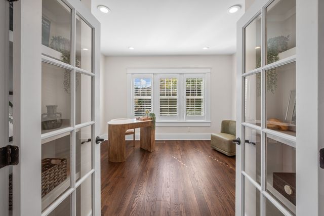 a living room with furniture a fireplace and a large window