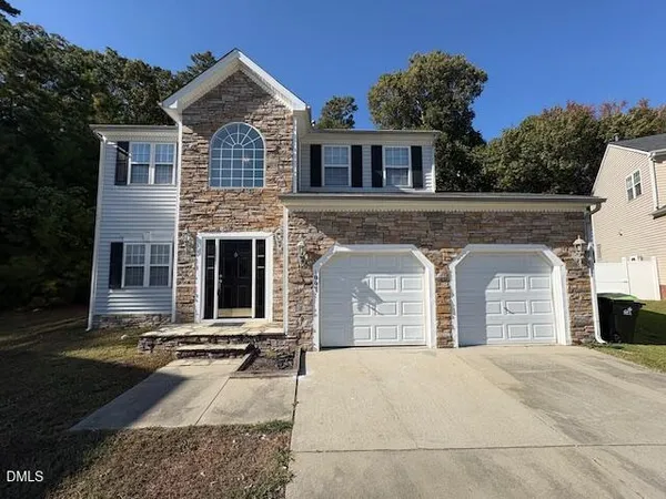 a front view of a house with yard