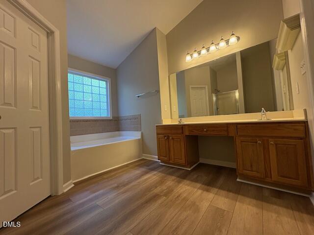 1007 Double Spring Court Apex, NC 27502 - Photo 13 of 22 a bathroom with a double vanity sink a mirror and a bathtub