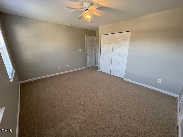 1007 Double Spring Court Apex, NC 27502 - Photo 18 of 22 an empty room with a ceiling fan and a window