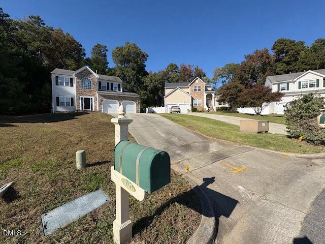 1007 Double Spring Court Apex, NC 27502 - Photo 2 of 22 a front view of a house with garden