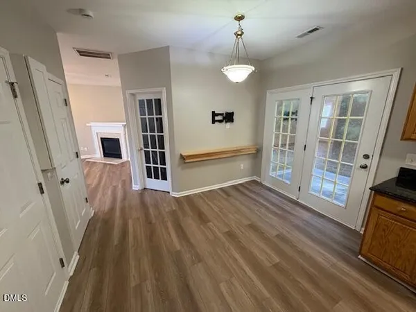 wooden floor in an empty room with a fireplace