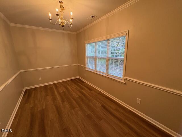 1007 Double Spring Court Apex, NC 27502 - Photo 9 of 22 a view of an empty room with a window and wooden floor