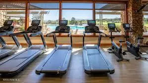 a view of a living room with furniture and floor to ceiling window