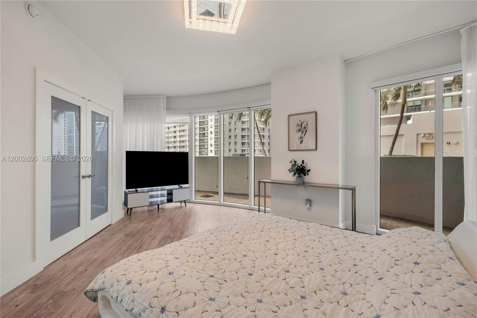 60 Southwest 13th Street, Unit 1124 Miami, FL 33130 - Photo 16 of 30 a bedroom with a bed and a flat screen tv