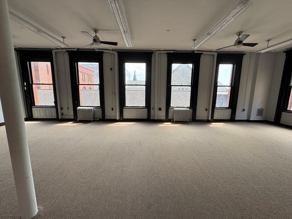 206 Seneca Street Oil City, PA 16301 - Photo 11 of 21 a view of an empty room with windows and chandelier