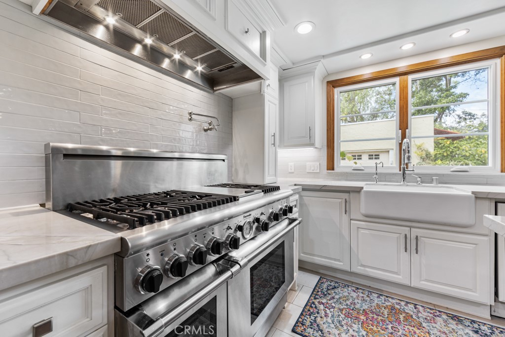 4031 Pine Avenue Long Beach, CA 90807 - Photo 29 of 70 a kitchen with granite countertop a stove and a sink