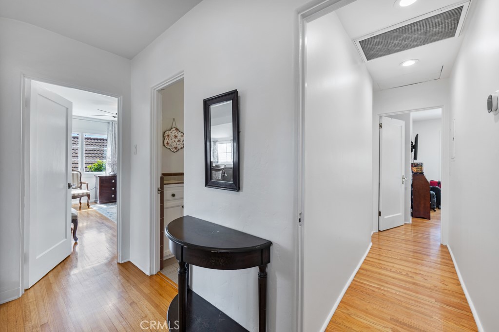 4031 Pine Avenue Long Beach, CA 90807 - Photo 48 of 70 a view of a hallway with wooden floor and staircase