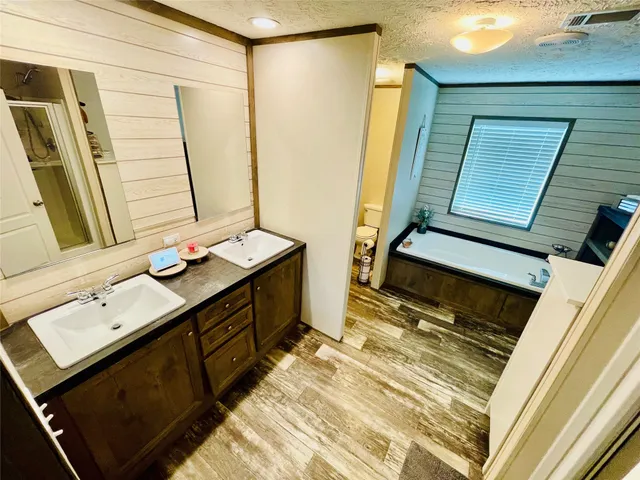 a bathroom with a sink a mirror and a shower