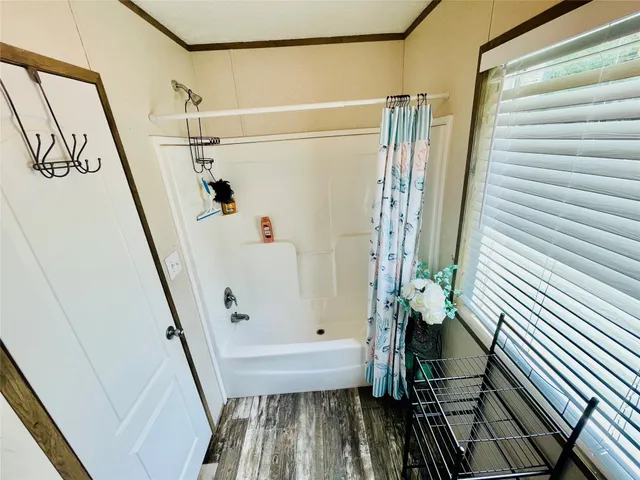 a bathroom with a bathtub and shower