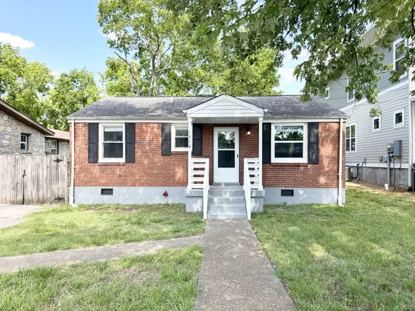 a front view of a house with a yard and porch