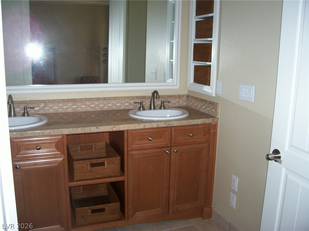 6 Via Vasari, Unit 104 Henderson, NV 89011 - Photo 8 of 13 Bathroom with double vanity and tile patterned floors