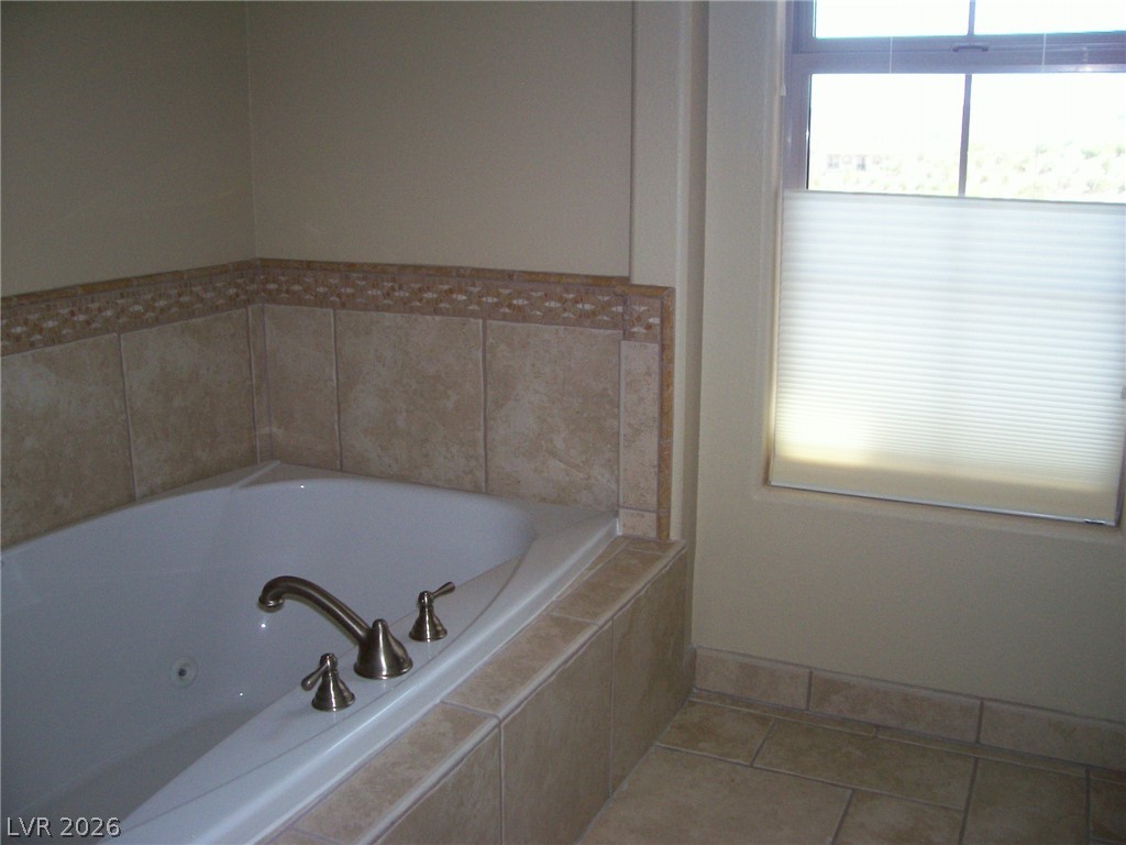 6 Via Vasari, Unit 104 Henderson, NV 89011 - Photo 9 of 13 Bathroom featuring a jetted tub and tile patterned flooring